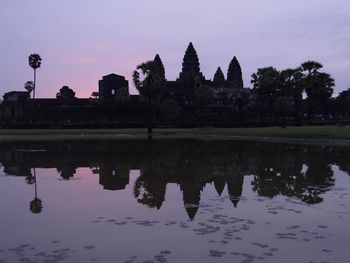 Calm lake with buildings in background