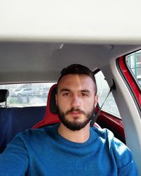 Portrait of man sitting in car