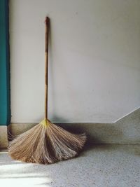  broom leaning against wall 