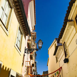 Low angle view of buildings against blue sky