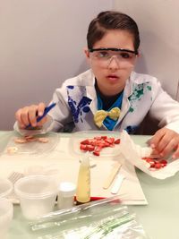 Portrait of boy doing science experiment with fruits