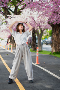 Full length of woman standing on road