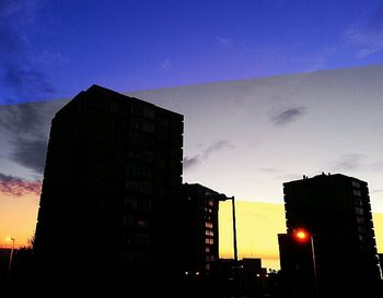 Low angle view of buildings against cloudy sky