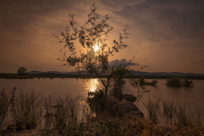 Scenic view of lake against sky during sunset