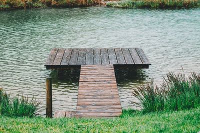 Built structure on field by lake