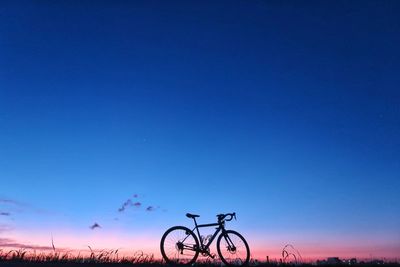 Bicycles against clear blue sky