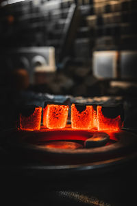 Close-up of lit candles on metal