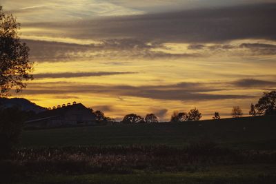 Scenic view of field against sky during sunset