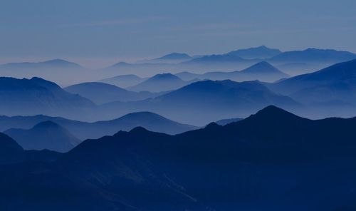 Scenic view of mountains against sky at dusk