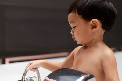 Portrait of shirtless boy sitting