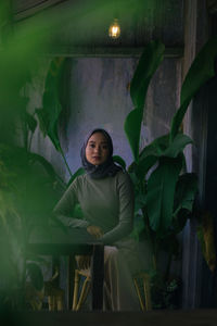 Portrait of young woman sitting in restaurant