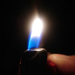 Close-up of hand holding candle