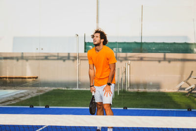 Tennis player standing on tennis court