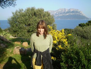 Young woman standing on grassy field