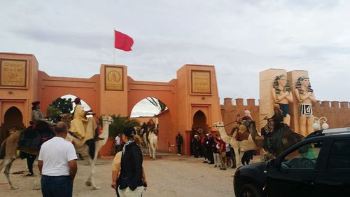 People in town square against sky