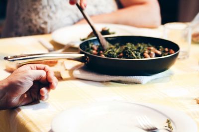 Close-up of hand holding food on table