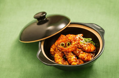 Close-up of prawns in casserole on table