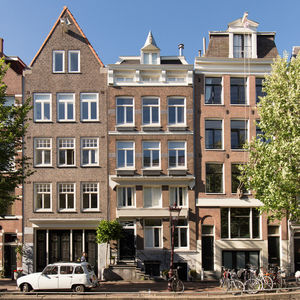 Residential building by street against sky