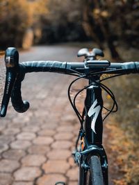 Close-up of bicycle parked on footpath