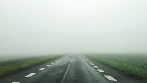 Road passing through landscape against sky