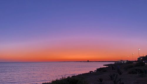 Scenic view of sea against romantic sky at sunset