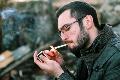 Close-up of man igniting cigarette