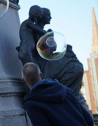 Rear view of man standing in city