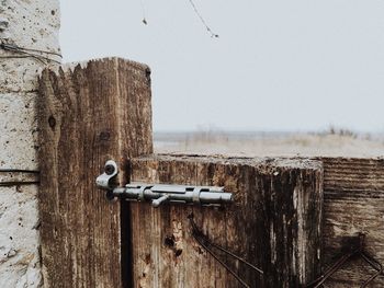 Close-up of old wooden door against clear sky