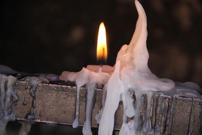 Close-up of burning candles in temple