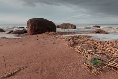 Rocks on beach against sky