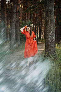 Peace of mind, breathing fresh air. alone woman in red dress enjoys the tranquility and calm