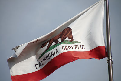 Low angle view of california flag against sky