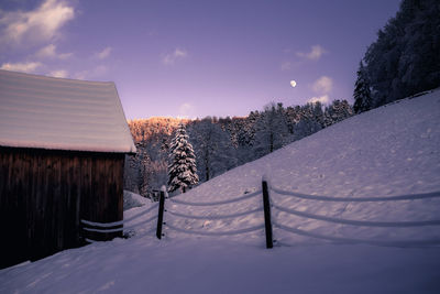 Snow covered field against sky