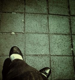 Low section of woman standing on tiled floor