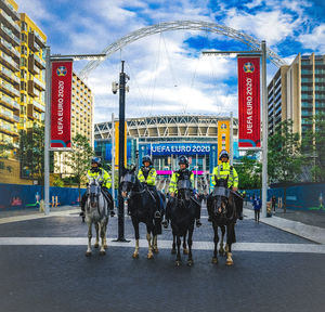 Group of people walking on street in city