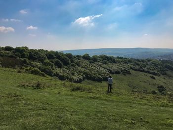 Rear view of man on landscape against sky