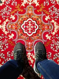 Low section of man standing on carpet