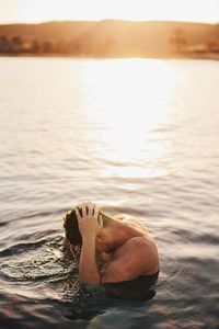 Low section of man relaxing in sea