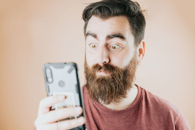 Portrait of young man using mobile phone