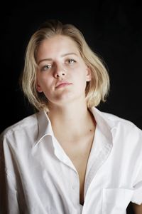 Portrait of a beautiful young woman over black background