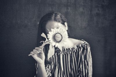 Portrait of a woman holding white flower