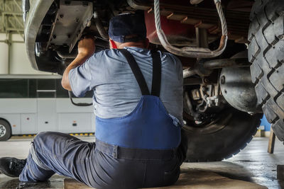 Rear view of man working in factory