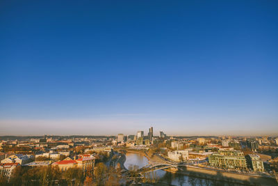 High angle view of buildings against blue sky