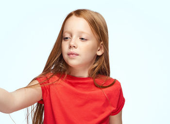 Portrait of young woman against white background