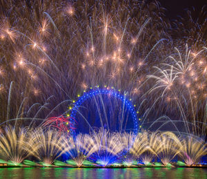 Low angle view of firework display at night