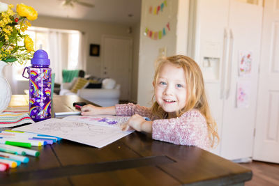 Portrait of young woman working at home