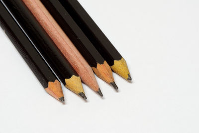 Close-up of colored pencils against white background