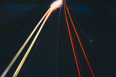 High angle view of light trails on road at night