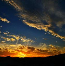 Silhouette of landscape against dramatic sky