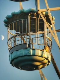 Low angle view of ferris wheel against clear blue sky